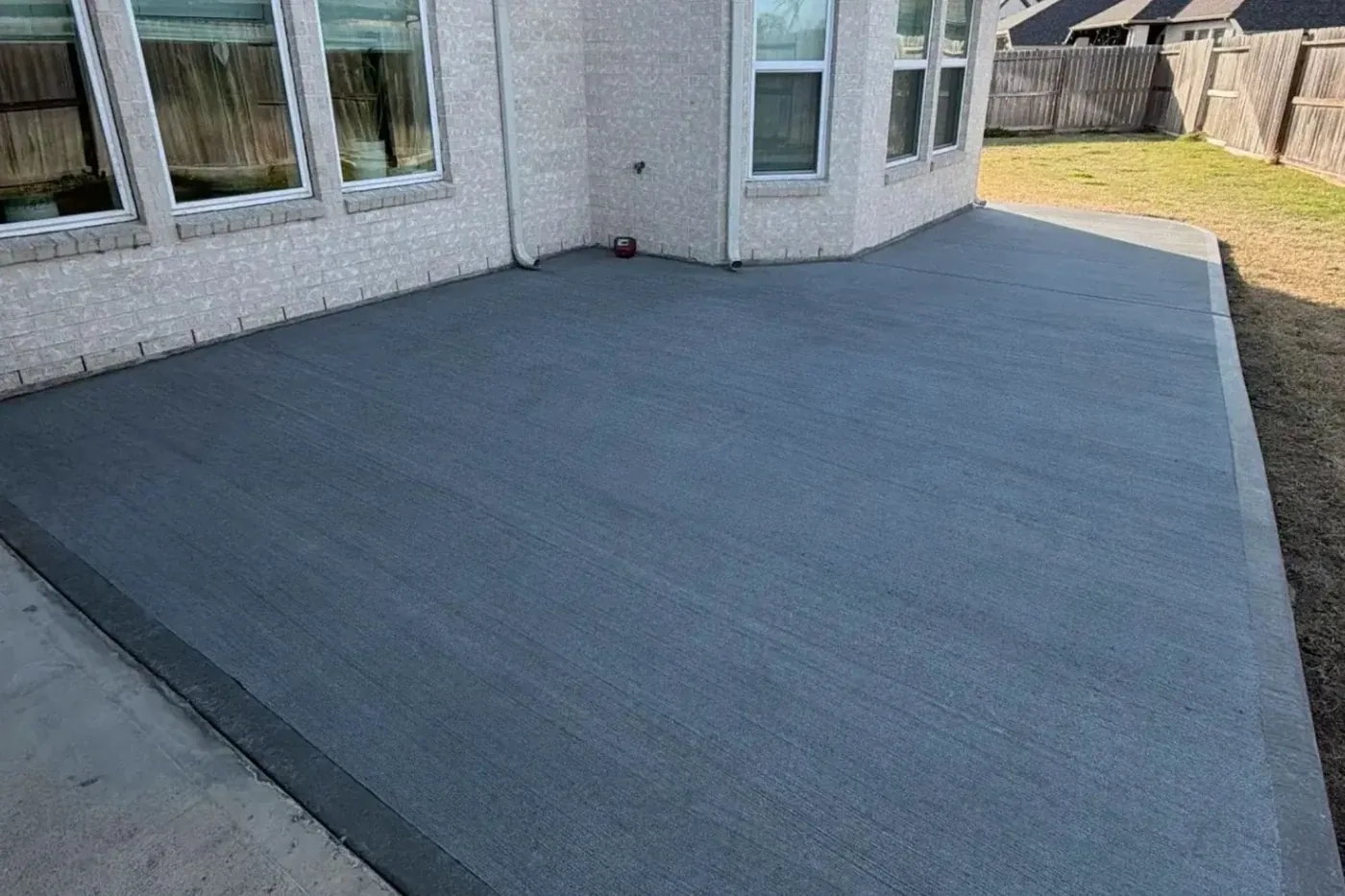 Finished broom-finish residential concrete patio by Billy's Concrete